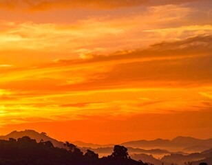 Sunrise over a misty mountain range