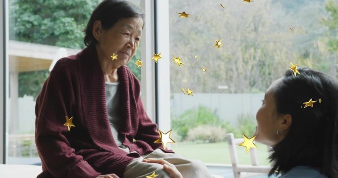 daughter placing hand on grandma knee sparking care talk as decorative stars overlaying home care