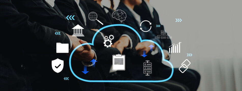 A professional business meeting scene featuring individuals in formal attire, with cloud technology icons symbolizing digital innovation, collaboration, and effective data management strategies. Trope - Powered by Adobe