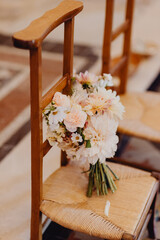 bouquet de fleurs de la mari&eacute;e pos&eacute; sur la chaise de l'&eacute;glise 