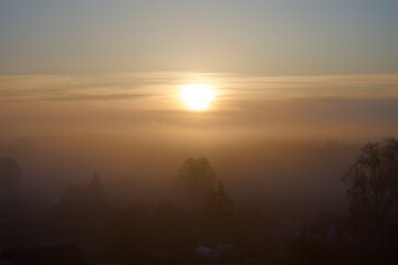 Sunrise with fog over the village