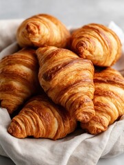 Heap of Freshly Baked Golden Croissants on Linen Cloth Close Up Still Life Food Photography Studio Shot