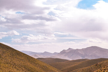 Beautiful image of the Atlas Mountains of Morocco, with an achievement giving a lot of depth. Decorated with a sky full of clouds in daylight.
