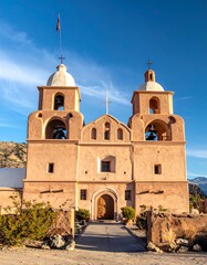 Fototapeta premium Spanish Colonial church facade, twin bell towers, arid landscape