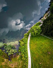 High-angle view of a winding road next to a lake