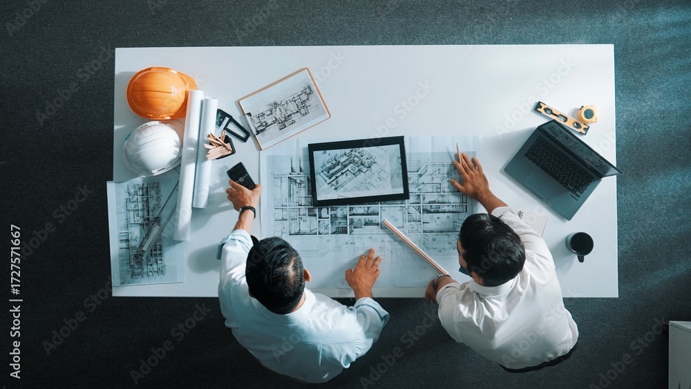 Poster top view of skilled civil engineer working together to plan building design. top down aerial view of
