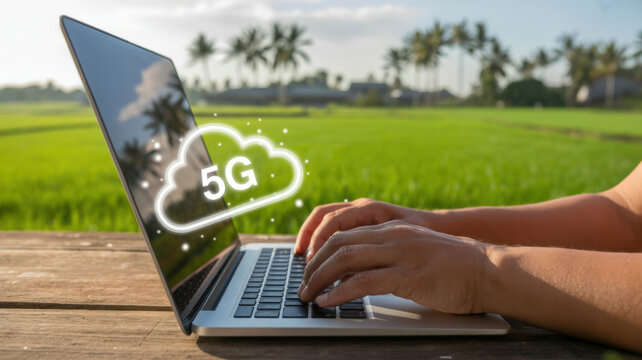 Person Typing on Laptop with 5G Cloud Symbol Over Rice Field and Palm Trees