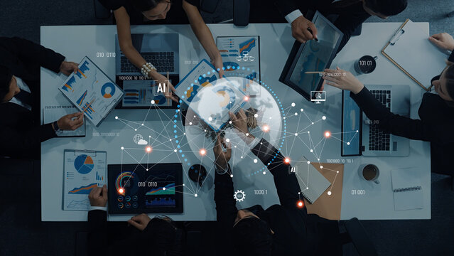 A diverse business team collaborates on data analytics and AI strategy, using digital visualizations and a global network in a modern conference room setting. Trope - Powered by Adobe