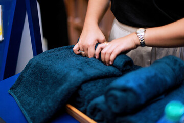 close up of hands rolling up a towel