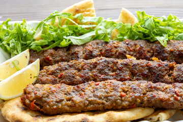 Close-up of traditional Turkish shish kebabs on oval plate