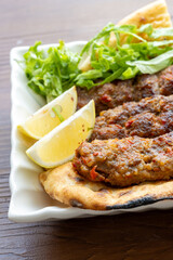 Close-up of traditional Turkish shish kebabs on oval plate