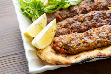 Close-up of traditional Turkish shish kebabs on oval plate