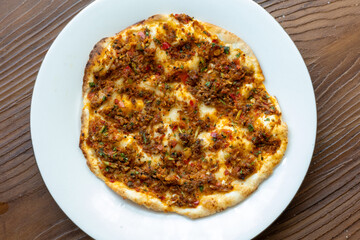 Traditional Turkish dish mini lahmacun in close-up