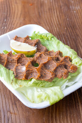 Making raw meatballs ( Turkish: Cig Kofte ) on wooden background	