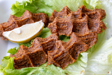 Making raw meatballs ( Turkish: Cig Kofte ) on wooden background	