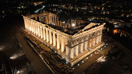 Aerial drone night shot of iconic illuminated world heritage site of Acropolis of Athens historic...
