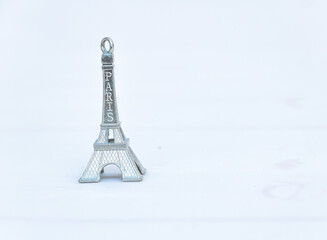 Miniature Eiffel Tower Paris souvenir figurine isolated on white background, symbolic travel gift from France