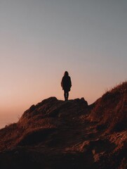 Naklejka premium Hiking Alone at Sunset on a Rocky Path With a Serene View