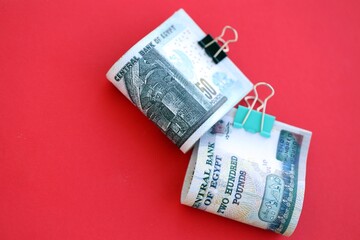 Egyptian pound money bills in big amount on red. Finance and banking concept