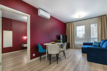 A cozy modern living space with stylish decor and beautiful views in a city apartment in daylight.
