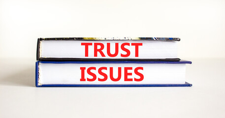 Trust issues symbol. Concept word Trust issues on beautiful books. Beautiful white paper background. Business trust issues concept. Copy space.