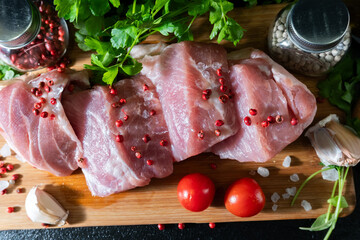 Raw Meat with Tomatoes and Parsley on Cutting Board