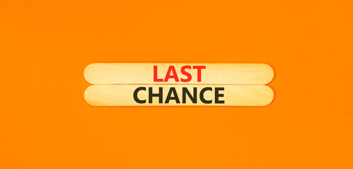 Last chance symbol. Concept word Last chance on beautiful wooden sticks. Beautiful orange paper background. Business last chance concept. Copy space.