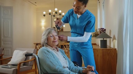 Supportive caregiver assisting a senior woman with a walker during rehabilitation at a nursing home. The patient is receiving professional help with mobility for a better and healthier life - Powered by Adobe