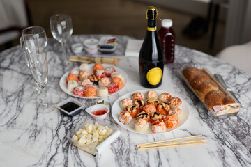 Enjoy a beautiful sushi spread and refreshing drinks elegantly served on a marble table