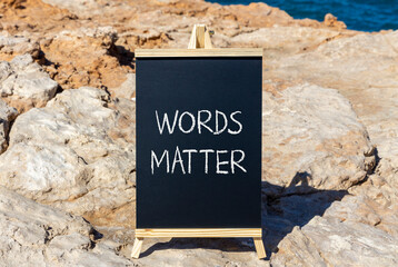 Words matter symbol. Concept word Words matter on beautiful black blackboard. Beautiful stone and...
