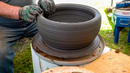 Potter Making Clay Pot on Pottery Wheel