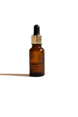 brown bottle with cosmetic oil and dropper cap, used, on white background