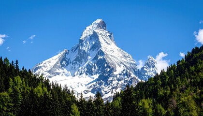Majestic, snow-capped mountain peak rises against a clear blue sky from lush greenery