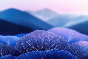 Close-up of delicate, translucent blue leaves against a blurred mountain backdrop.
