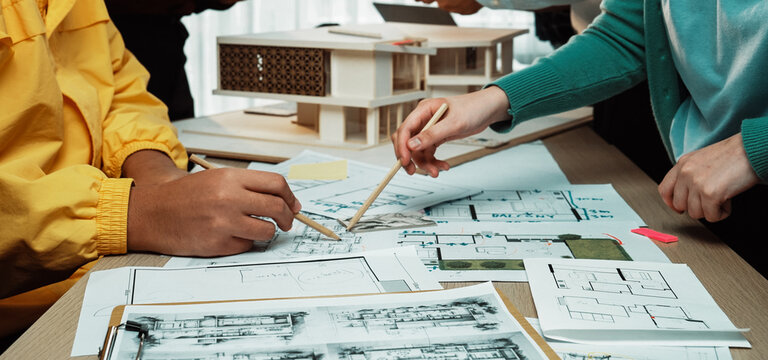 A dynamic scene showcasing a collaborative architecture meeting with professionals analyzing blueprints, sketches, and a scale model, emphasizing teamwork and creativity. SACTR