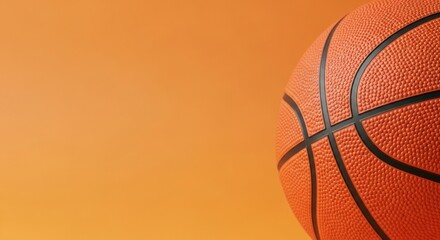 Fototapeta premium Close-up of an orange basketball against a gradient orange background.
