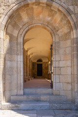 Obraz premium Historical buildings with arches in Greece. Old stone architecture at Filerimos Monastery on Rhodes Island Greece