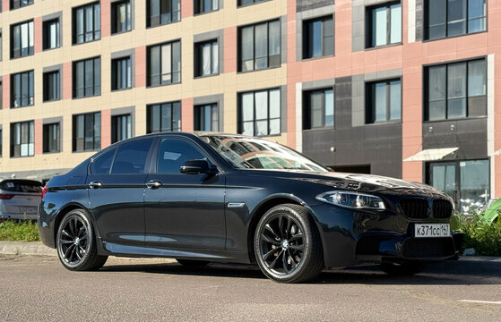 BMW 5 Series M5 VI F10,F11,F07 black color parked on street. Exterior of a black car. Black sport sedan BMW 5-Series F10 M5 sport on parking lot. Germany car. 