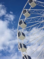 Ferris Wheel Against Blue Sky with Clouds