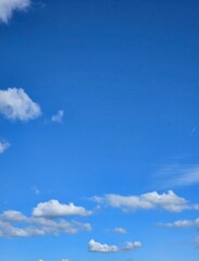 Clear blue sky with puffy white cumulus clouds