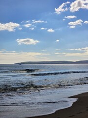 sunny day at the beach with sand and water