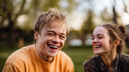 Fototapeta premium Young man laughing happily in inclusive outdoor setting