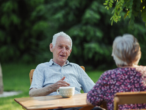Older couple sharing moment in sunny garden