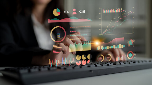 A business professional engages with advanced data visualizations, highlighting trends and insights while using a modern keyboard in a sleek office space. Impute - Powered by Adobe