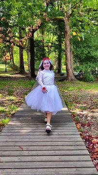 A girl in a white dress and a veil, the image of a scary bride, a zombie, dancing coolly, on Halloween