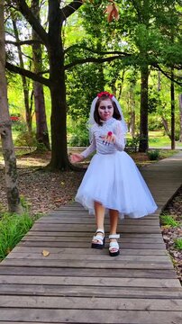A girl in a white dress and a veil, the image of a scary bride, a zombie, dancing coolly, on Halloween
