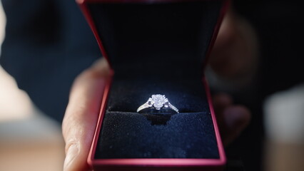 Hand showing wedding ring at apartment closeup. Boyfriend proposing marriage