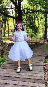 A girl in a white dress and a veil, the image of a scary bride, a zombie, dancing coolly, on Halloween
