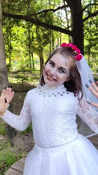 A girl in a white dress and a veil, the image of a scary bride, a zombie, dancing coolly, on Halloween