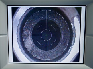 Close-up view of an optical lens with grid overlay